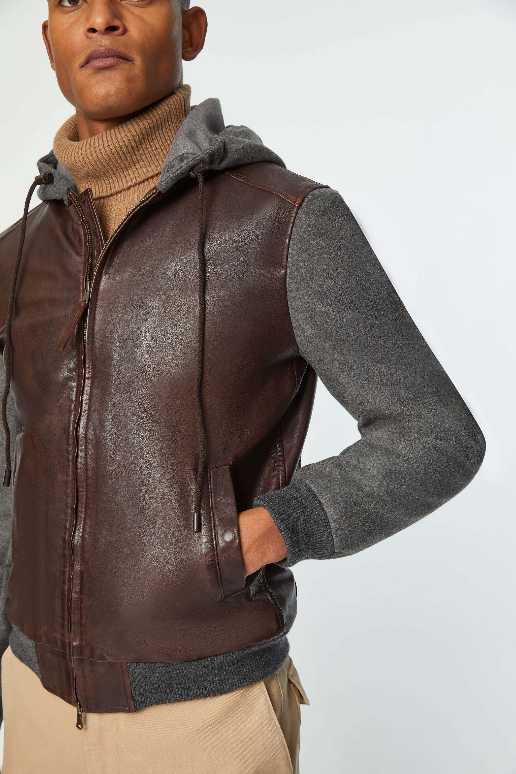 Leather bomber jacket with sweatshirt fabric inserts